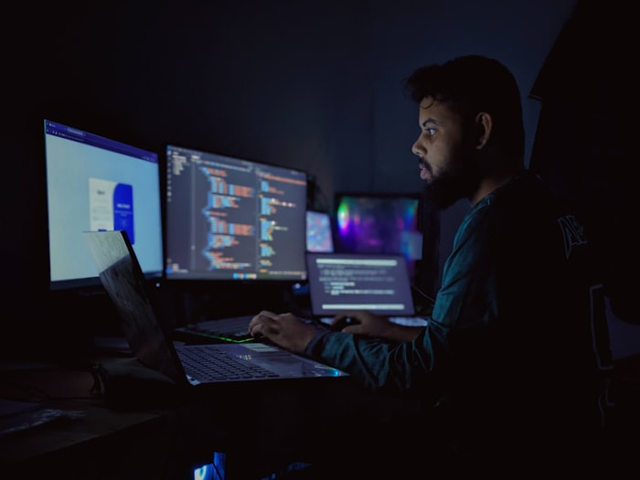 A dual-monitor developer setup showing code and terminal windows