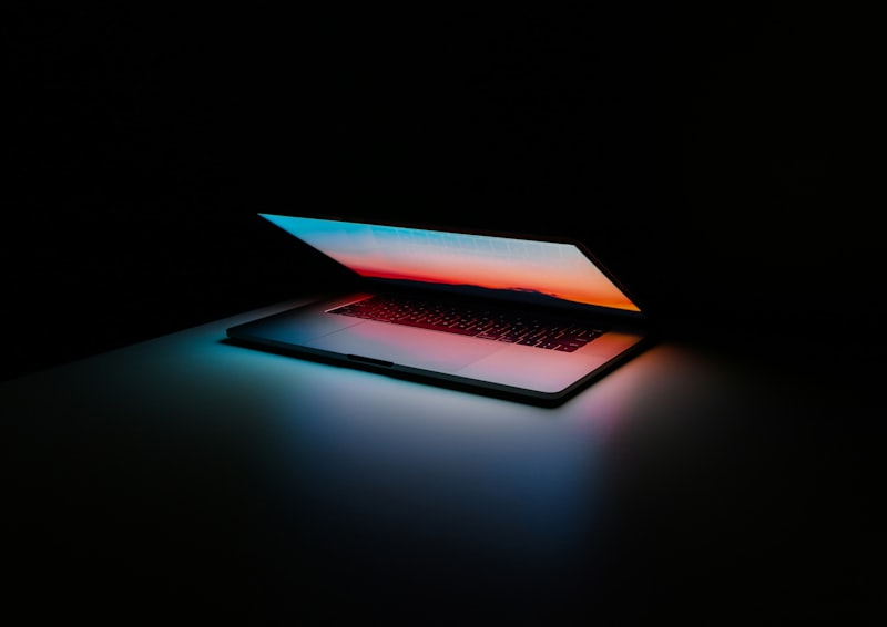 A secure laptop displaying data visualization on a dark desk
